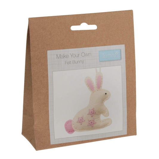 External view of the Felt Decoration Kit: Bunny. Showcasing the eco friendly brown paper bag. Along with an example of the finished rabbit.